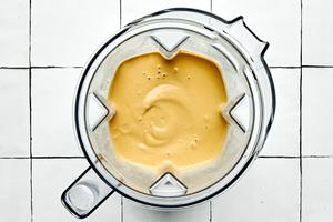 a blender full of quinoa bowl sauce made with almond flour, garbanzo beans, edamame, nutritional yeast, and spices
