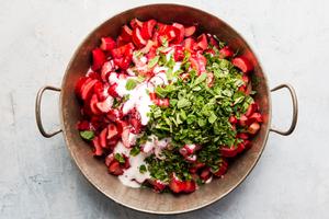 chopped rhubarb on a round baking dish with sugar and mint