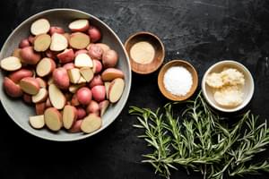 baby potatoes in a bowl, fresh rosemary, salt, garlic powder