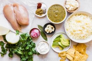ingredients for salsa verde nachos shown in a prep bowls