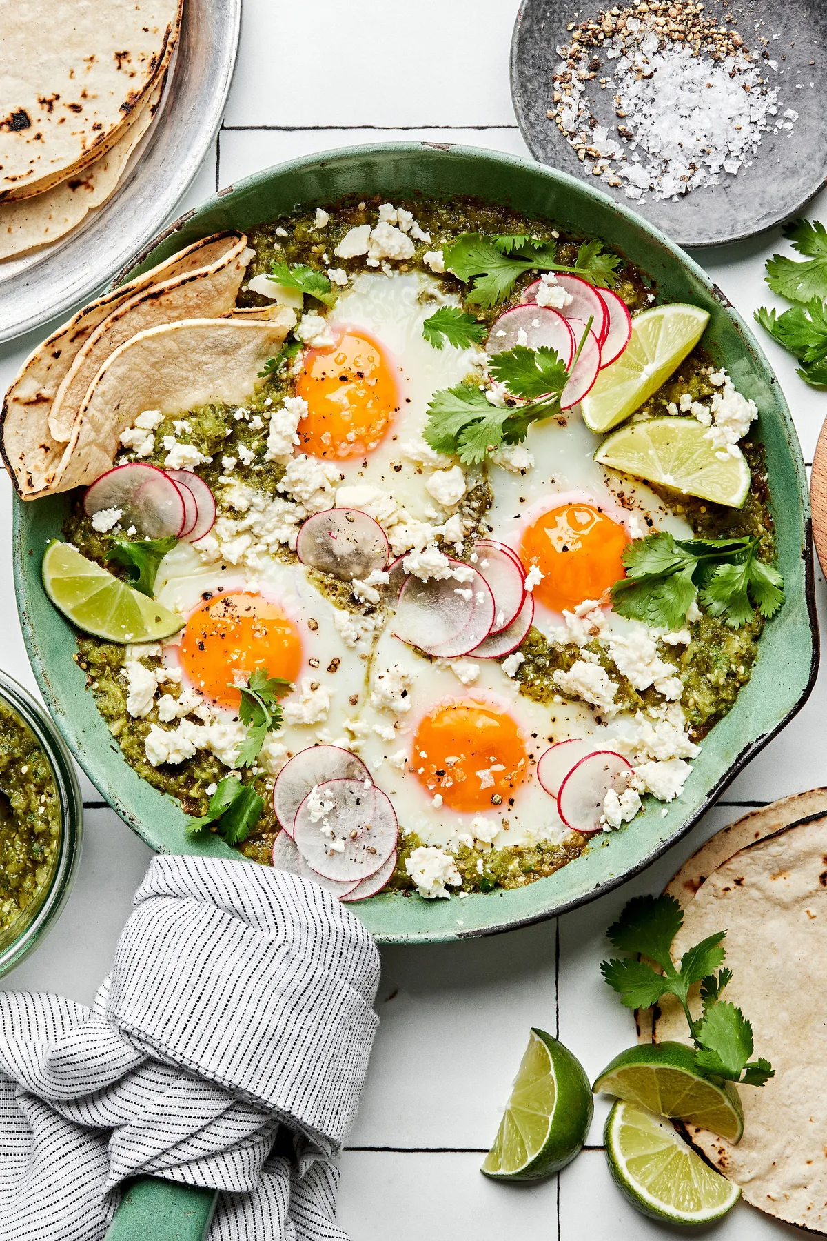 salsa verde baked eggs sprinkled with cotija & cilantro served with corn tortillas in a list of the best breakfast egg dishes
