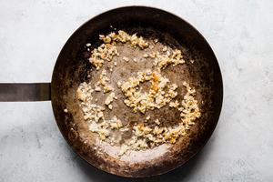 Toasted sesame oil, cloves garlic, minced and grated ginger in sautéd in a pan