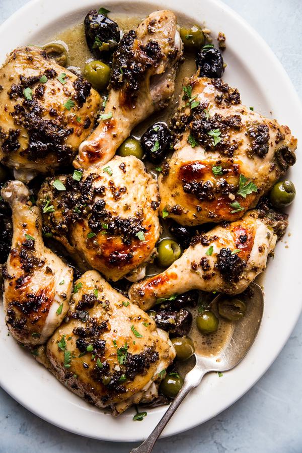 chicken marbella on a white platter with olives and dates