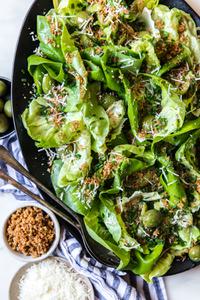 Butter lettuce Salad with manchego cheese, green olives and panko bread crumbs on a plater