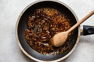 soy sauce, Sesame oil, chili sauce, brown sugar, honey, Garlic, ginger sautéed in a pan for shrimp lettuce cups