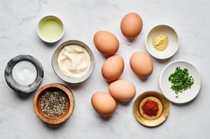 boiled eggs, mayo, dijon mustard, pickle brine, salt and pepper in prep bowls to make deviled eggs