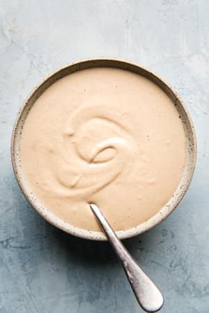 tahini sauce in a bowl with a spoon