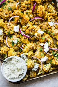 Tandoori Chicken Sheet Pan dinner with cauliflower, and chickpeas served with a bowl of Raita