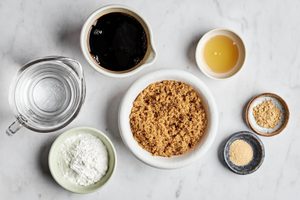 ingredients for teriyaki sauce laid out and measured: water, cornstarch, honey, garlic, ginger, soy sauce and brown sugar