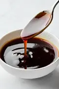 Glossy and rich Homemade teriyaki sauce dripping smoothly from a spoon