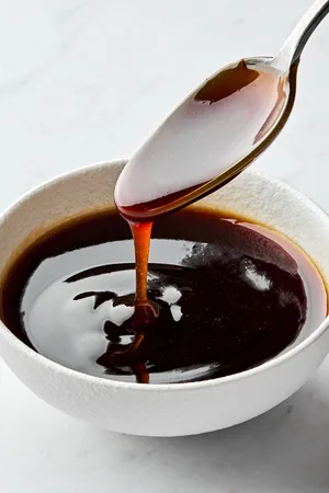 Glossy and rich Homemade teriyaki sauce dripping smoothly from a spoon