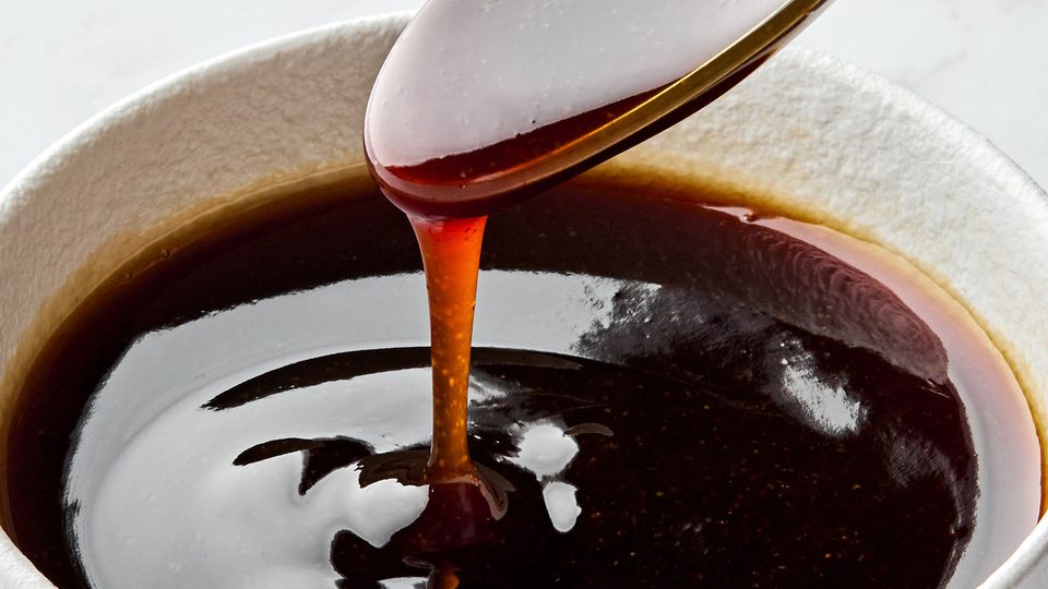 Glossy and rich Homemade teriyaki sauce dripping smoothly from a spoon