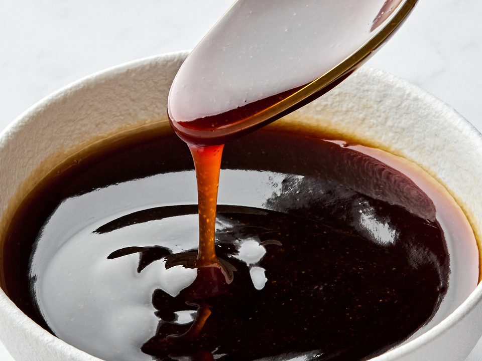 Glossy and rich Homemade teriyaki sauce dripping smoothly from a spoon