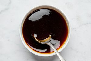 a bowl of dark, glossy homemade teriyaki sauce made with cornstarch, honey, garlic, ginger, soy sauce and brown sugar