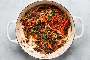 thai beef basil in a large white skillet