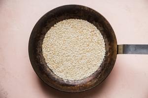 Toasted rice shown in a large metal skillet
