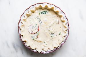 tomato, fresh basil and caramelized onions in a raw pie crust with egg and cream mixture