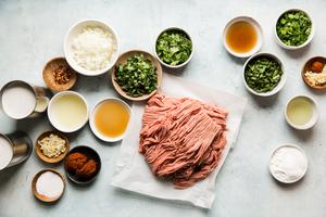 ingredients for Thai curry meatballs in small bowls. Ground turkey, basil, red curry paste and coconut milk
