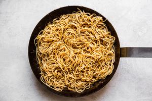 fresh chow mein noodles cooked in sauce in a large skillet