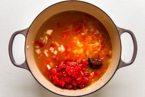 red peppers and onions along with crushed tomatoes and chick stock in a large pot