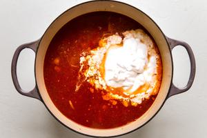 coconut curry soup broth with coconut cream added to the pot