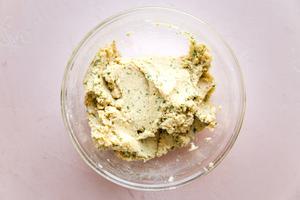 a bowl of falafel mixture made with Chickpeas, onion, garlic, parsley, cilantro, cayenne, cumin, salt, baking powder & flour