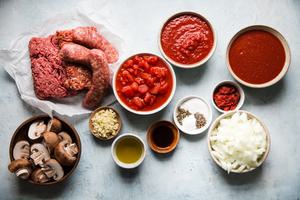 ground pork, beef and sausage, mushrooms, olive oil, garlic, canned tomatoes, tomato sauce, onions, salt and pepper