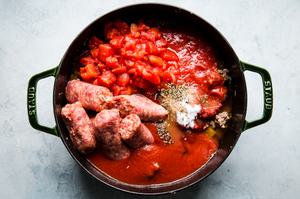 ground beef, ground pork, mushrooms, onions and garlic in a pot with sausage links, spices, tomatoes and tomato sauce