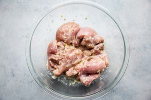 chicken thighs in a mixing bowl with a lemongrass marinade
