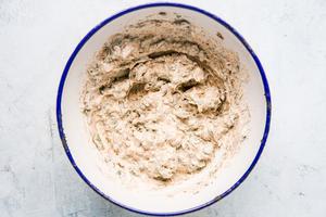 White enamel bowl filled with herbed may mixture for grilled chicken sandwich.