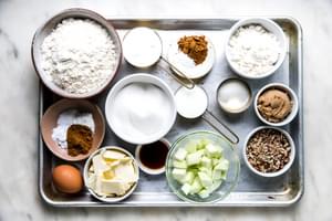 homemade apple crumb cake ingredients in bowls on a baking sheet