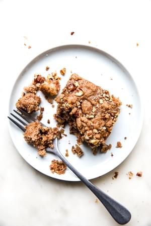 a piece of homemade apple crumb cake on a plate with a fork