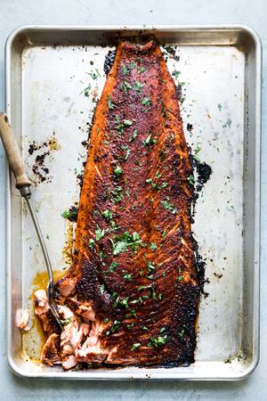 baked salmon a baking sheet seasoned with brown sugar, salt, paprika, garlic powder and pepper