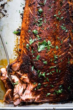 baked salmon flaked a baking sheet sprinkled with parsley