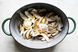 onion, garlic and spices cooking in a dutch oven