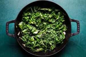 olive oil, garlic and greens in a skillet