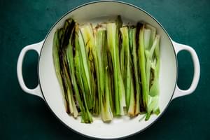 sliced leeks in a skillet cooked with a light golden color