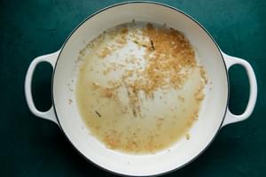 white wine, white wine vinegar and shallots in a skillet