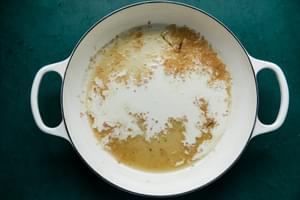 white wine, white wine vinegar, shallots, heavy cream, salt and pepper in a skillet