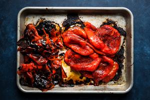 homemade roasted red peppers on a baking sheet