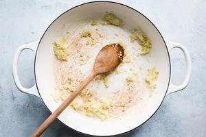 onions, garlic and ginger cooking in a pot with olive oil