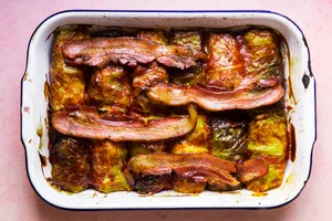 Warm Polish cabbage rolls stuffed with ground beef, sausage and rice, baked to perfection, topped with ketchup & crisp bacon.