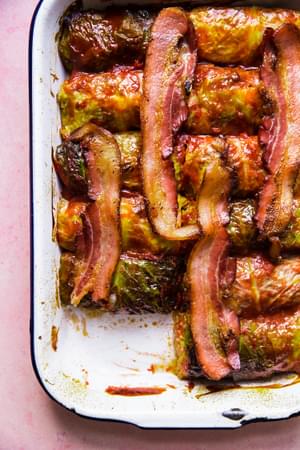 Warm Polish cabbage rolls stuffed with ground beef, sausage and rice, baked to perfection, topped with ketchup & crisp bacon.