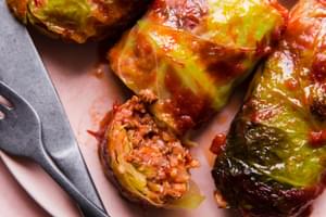 Warm Polish cabbage rolls stuffed with ground beef, sausage and rice, baked to perfection, topped with ketchup & crisp bacon.