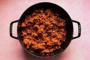 ground beef and pork sausage browned with onion, white rice, tomato paste and ketchup mixed together in a Dutch oven
