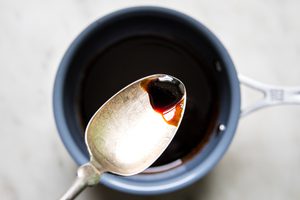 homemade balsamic glaze in a bowl with balsamic vinegar, brown sugar, and garlic.