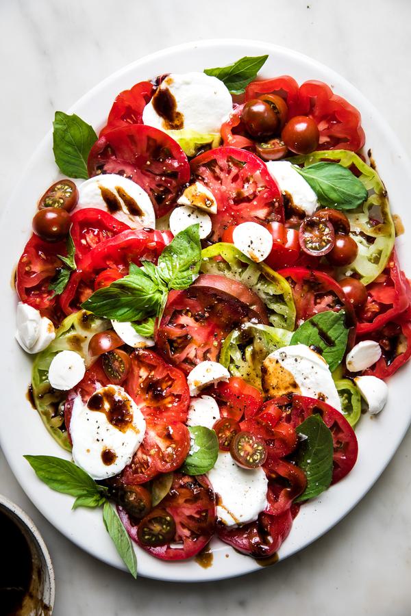 homemade caprese salad made with mozzarella, tomatoes, basil and balsamic