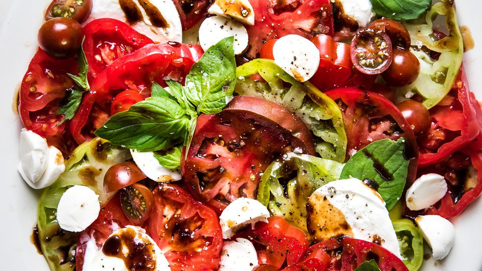 homemade caprese salad made with mozzarella, tomatoes, basil and balsamic