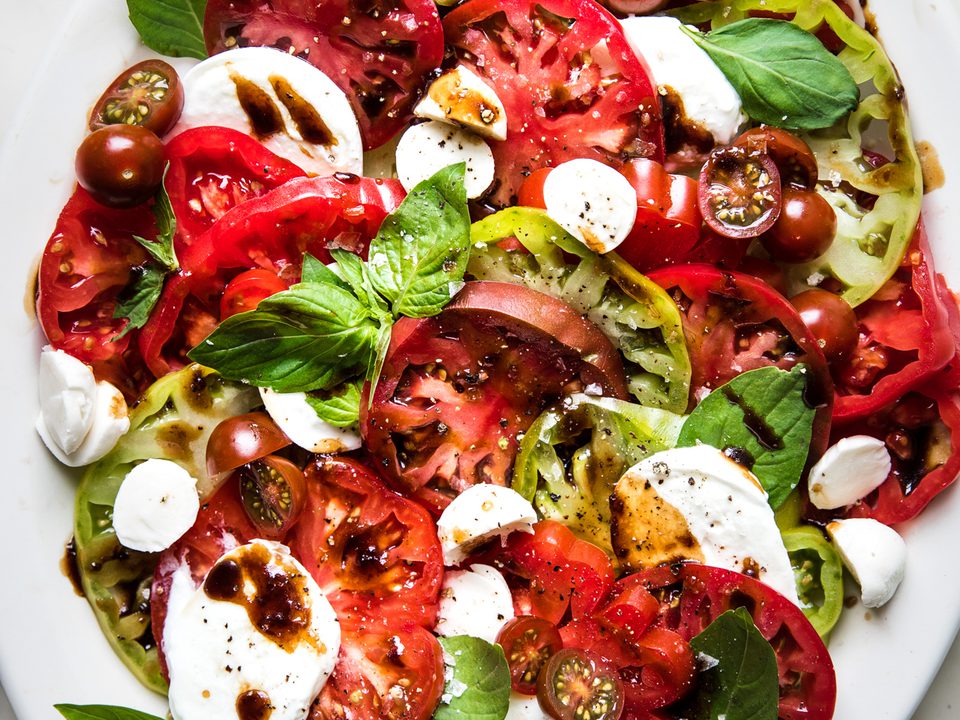 homemade caprese salad made with mozzarella, tomatoes, basil and balsamic