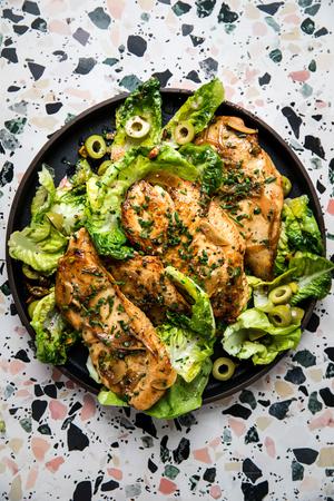chicken paillard on a plate with a salad